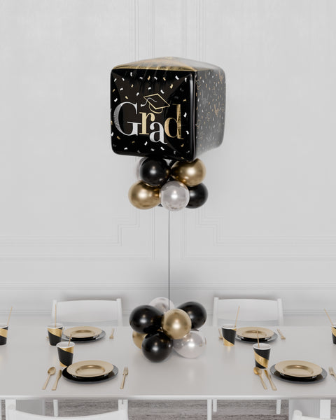 Grad Cubez Balloon Centerpiece in Black, Gold, and Silver. Sold by Balloon Expert