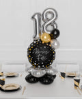 Happy Birthday Quad Number Balloon Centerpiece in Black, Gold, and Silver, inflated with air